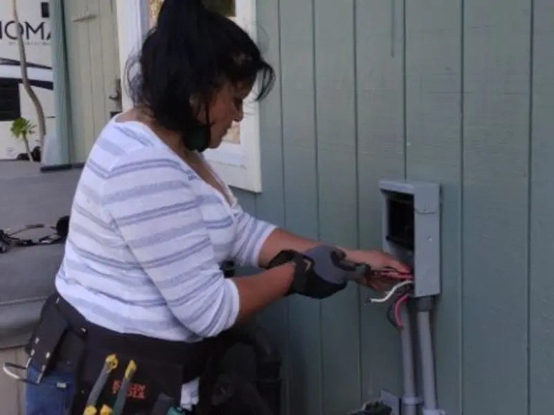 Licensed electrician wiring an exterior subpanel in Artesia